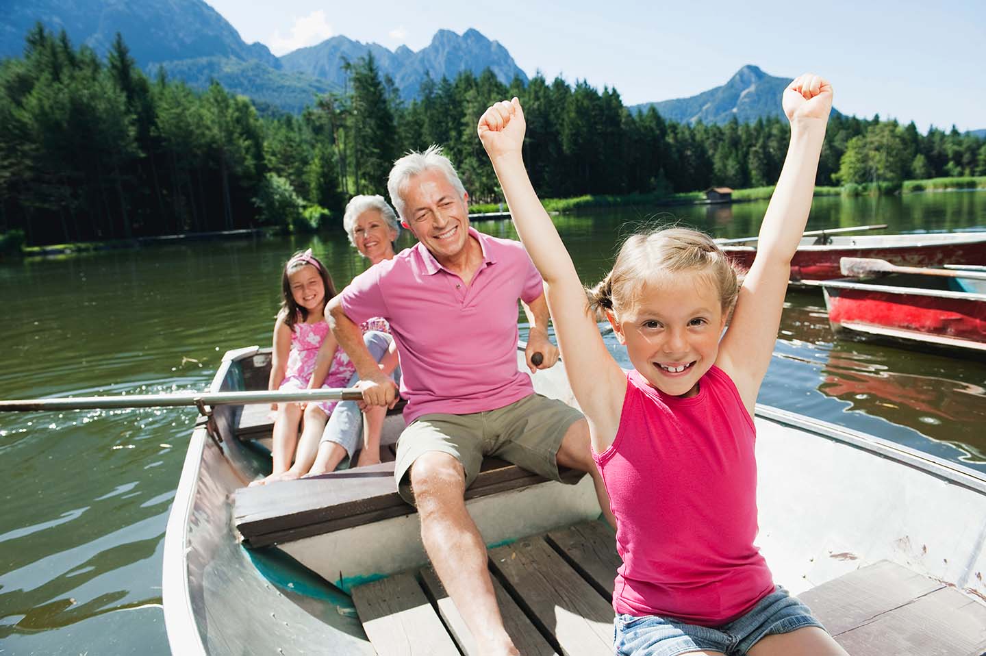 grandparents take their grandkids boating on the lake