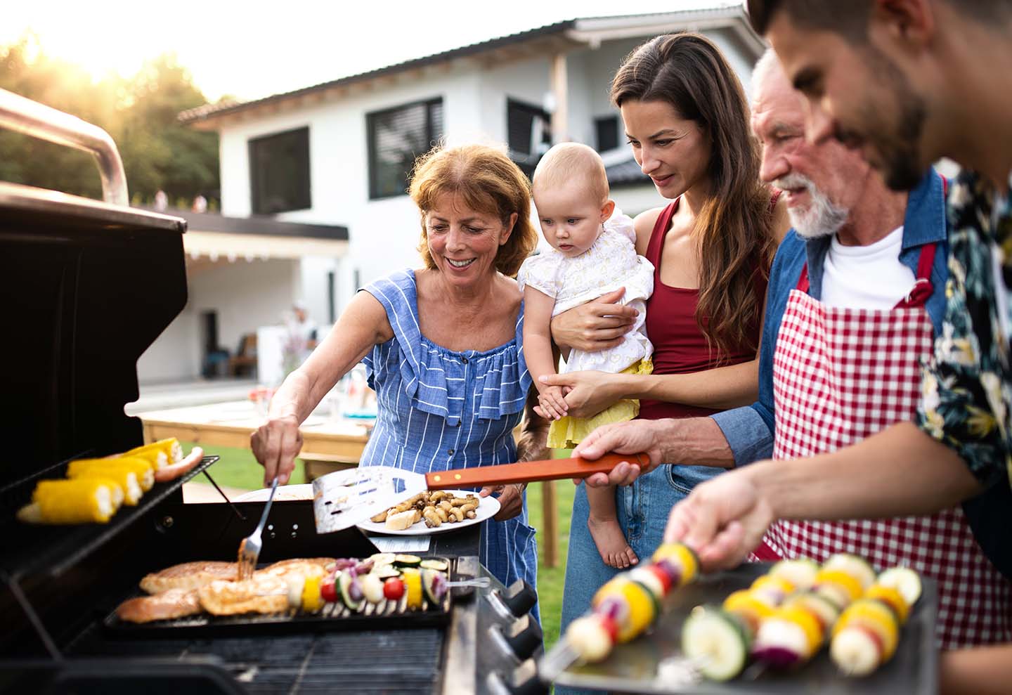 multigeneration family enjoys a summer bbq