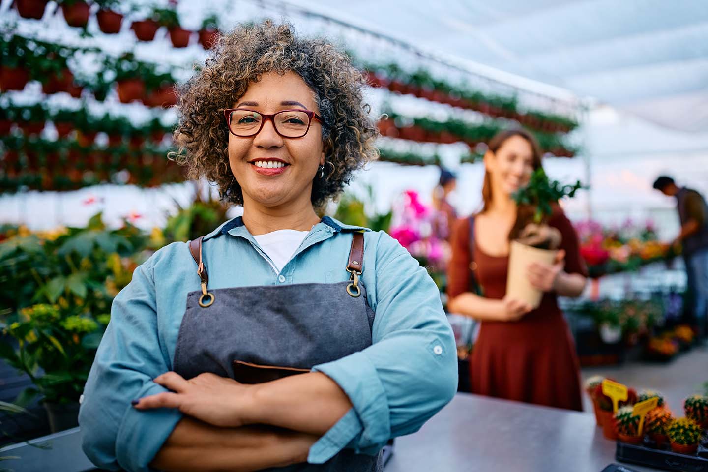 proud small business owner at her plant nursery